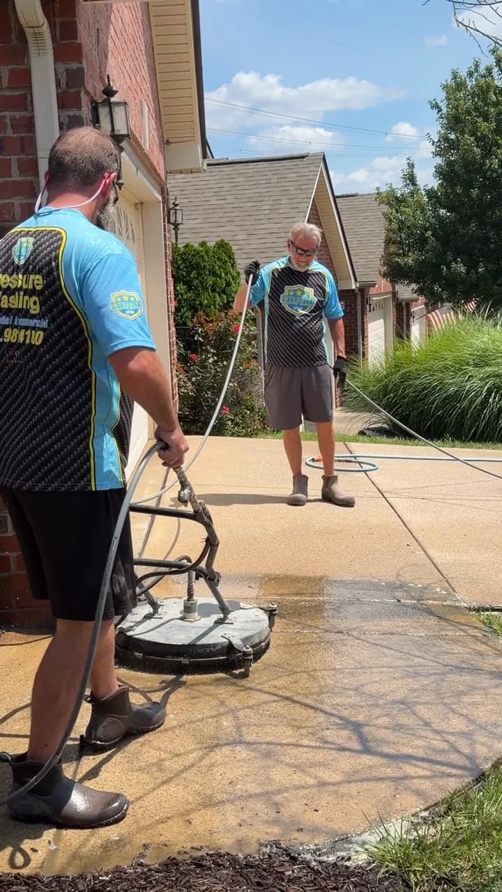 Integrity Pressure Washing crew surface cleaning a driveway