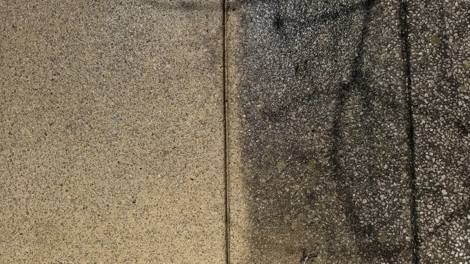 Side-by-side driveway concrete cleaning result from Integrity Pressure Washing.