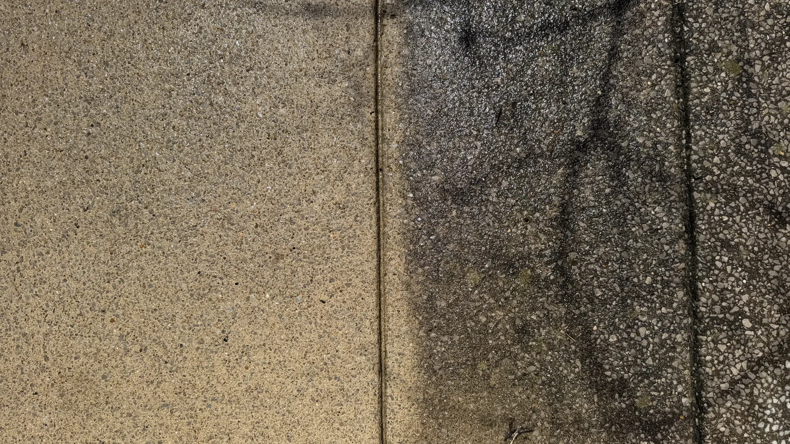 Side-by-side driveway concrete cleaning result showing stained concrete next to cleaned concrete.